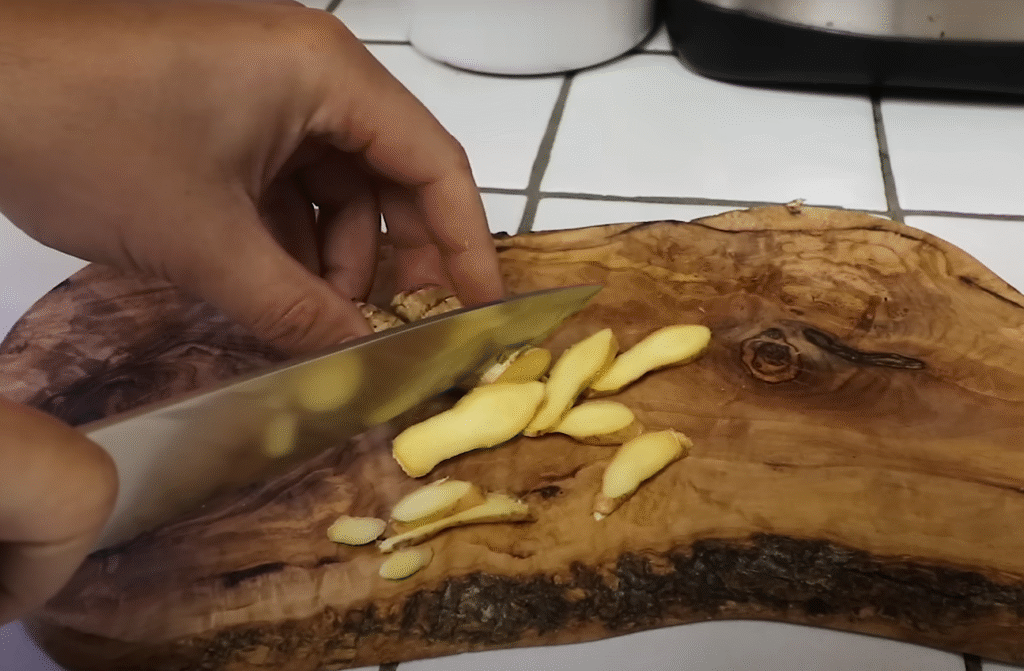 chopping ginger in small slices