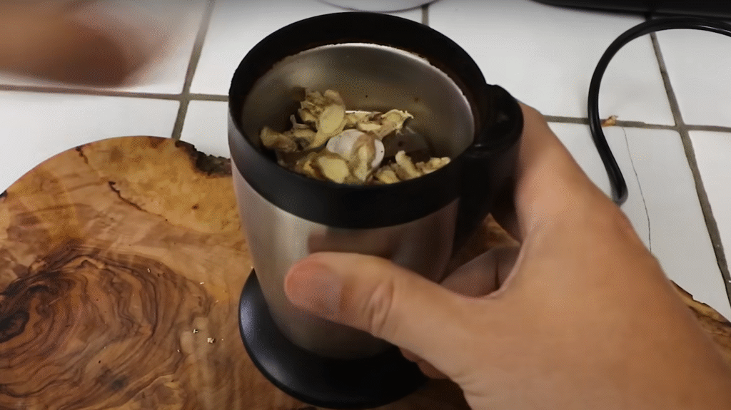 Grinding the dried slices in a spice grinder.